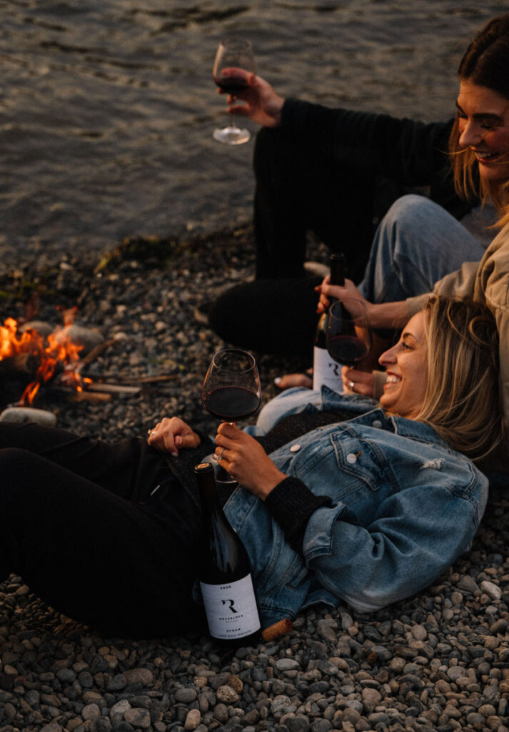 Two women drinking Rockblock Cellars Syrah Campfire Relaxing